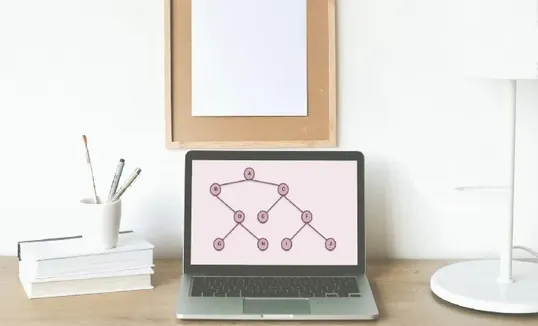 This image contains an open laptop, and a visual data structure representation of a binary search tree in the screen.